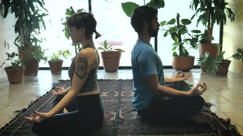 Man and woman in sitting yoga pose