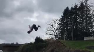 Guy black shorts back flip rope swing