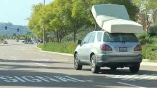 Car suv driving with mattress bed on roof