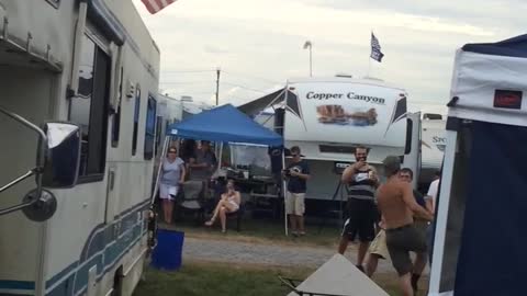 Frat Bro Holding American Flag Leaps From RV On To Flimsy Table
