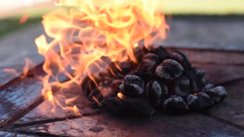 Coals burning and Set ablaze with lighter fluid