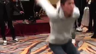 Guy in grey hoodie sweater back flips fail