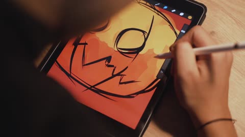 person drawing an artwork on the tablet