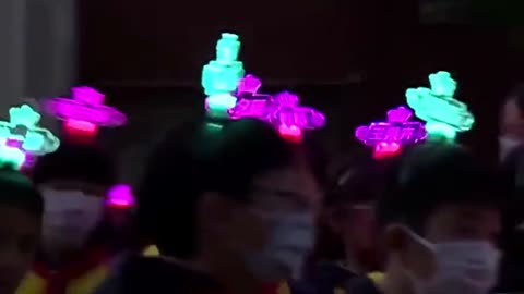 Chinese students wear luminous name tags on their heads to help parents locate them in the dark
