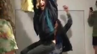 Guy in black sweater falls down from ceiling