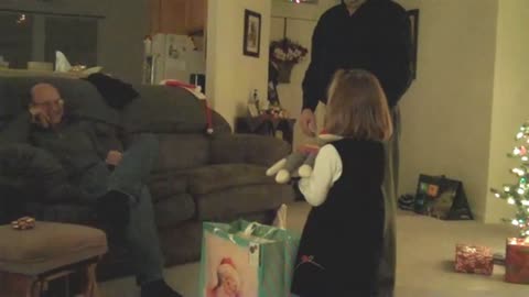 Young girl gets a sock monkey for christmas