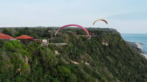 Paragliding over south coast in Bali Indonesia