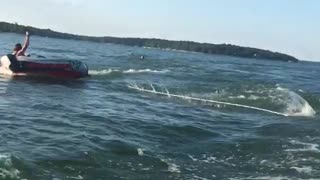 Three people raft boat lake one person falls off girl into water