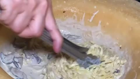 Pasta prepared in cheese wheel with mushroom