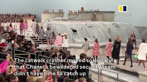 Watch Marie Benolie crash Chanel's runway at Paris Fashion week and Gigi Hadid kick her out