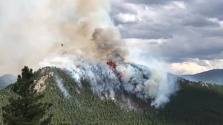 Helicopters engage in direct aerial attack on the Elephant Butte Fire in Evergreen, Colorado