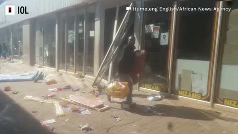 Police battle with looters at Letsoho Shopping Centre in Katlehong.