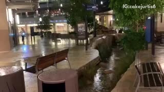 Guy tries to jump over a fountain with an electric scooter, falls into the fountain