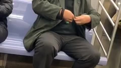 Man clips his fingernails on a subway train