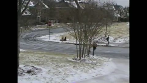 Kid Sleds Down Sidewalk And Racks Himself On A Stop Sign