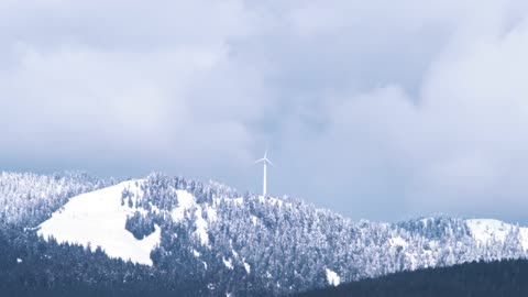 Beautiful Mountain with windmill and covered with freezing snow