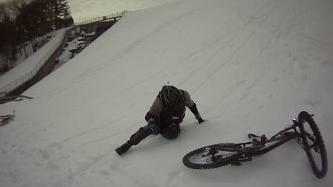 Man Crashes Bike Down Snowy Hill