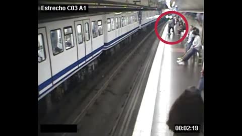 Metro Passenger Walks Onto Tracks Staring At Mobile