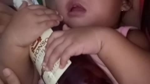 Baby Cuddles Bottle At Bedtime