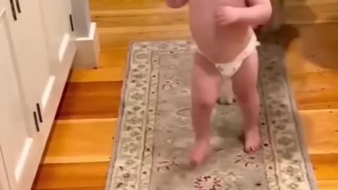 Baby likes to play with the dog