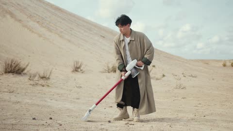 Man using Vacuum Cleaner in Desert