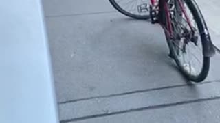 Man fishes through subway grate on the ground