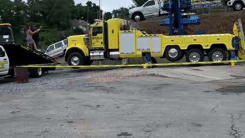Towing Company Owners Use Crane and Car for Gender Reveal