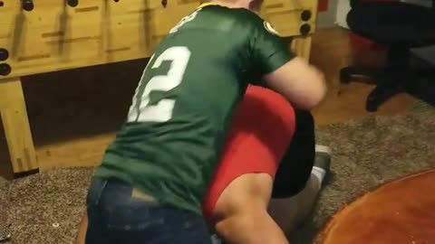 Nsfw guy in green rodgers jersey gets tackled by guy in red beer pong