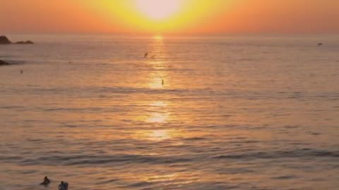 Sunset in the open sea from the top of a beach