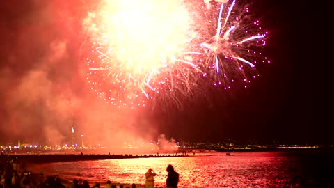 Fireworks illuminating the beach sky