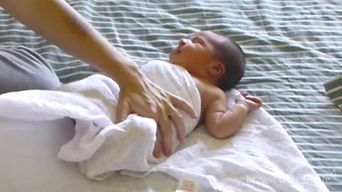 How to swaddle a baby, a calming technique. By Breast Time of Life.