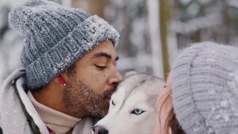 Couple Kissing their Pet Dog