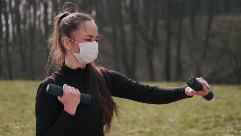 Woman Exercising While Wearing a Face Mask