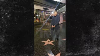 George Lopez pretends to urinate on Trump's Hollywood star.