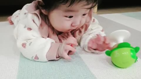 A lovely baby playing with toys