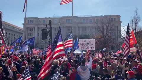 Thousands of Trump supporters sing the “Star Spangled Banner” in unison.