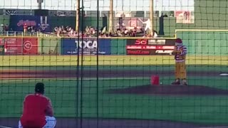 Ronald McDonald throws the first pitch at baseball game.
