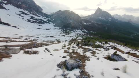 A drone that depicts a beautiful landscape that includes various mountains covered with snow