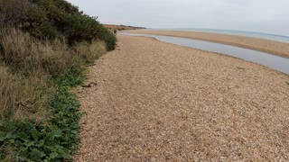 Hiking on a beach on a cloudy day. Speedlapse.