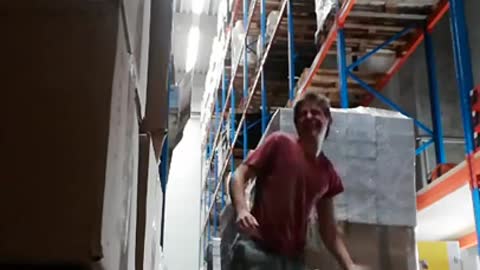 Red shirt guy handstand on cardboard box warehouse fail