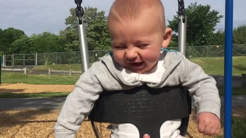 Slow motion captures baby's joy in swing set