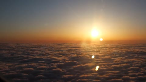 View of a beautiful sunset above the clouds from my window seat.