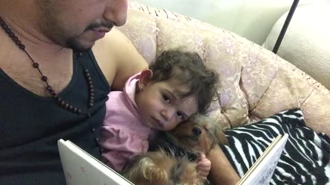 Baby and puppy fall asleep during bedtime story