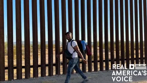 Man visiting border actively watches people cross into america