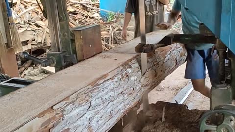 Sawing Long Red Mahogany Wood For A Truck Bed At A Sawmill