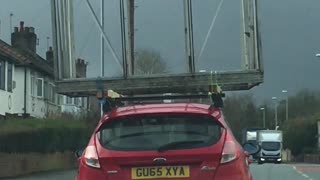 Car Towing a Greenhouse on Roof