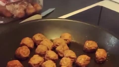 A sitting dog salivating because of frying bean cake