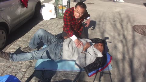 Luodong Massages Black Man In Gray Sweatshirt On Sidewalk