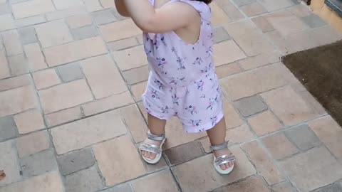 Baby throws a ball a clap herself