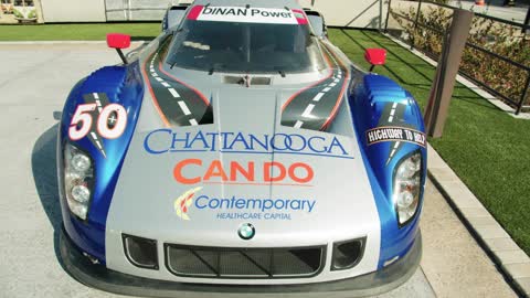 A Racing Car On Display Outdoors In A Car Show